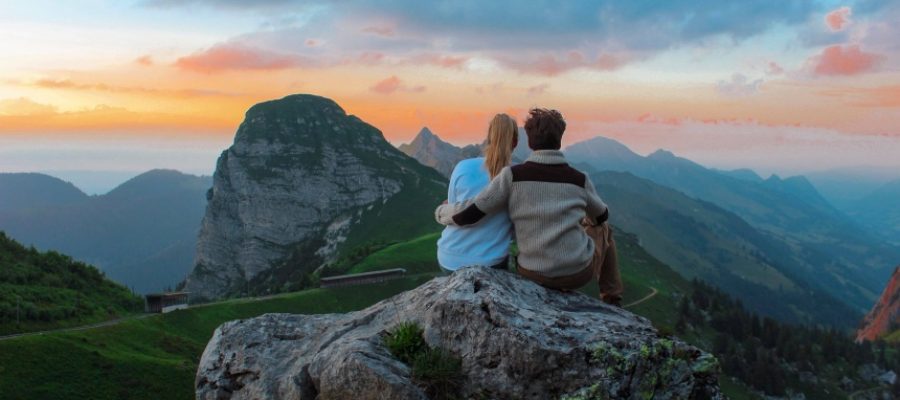 Man and woman on mountaintop, sitting together